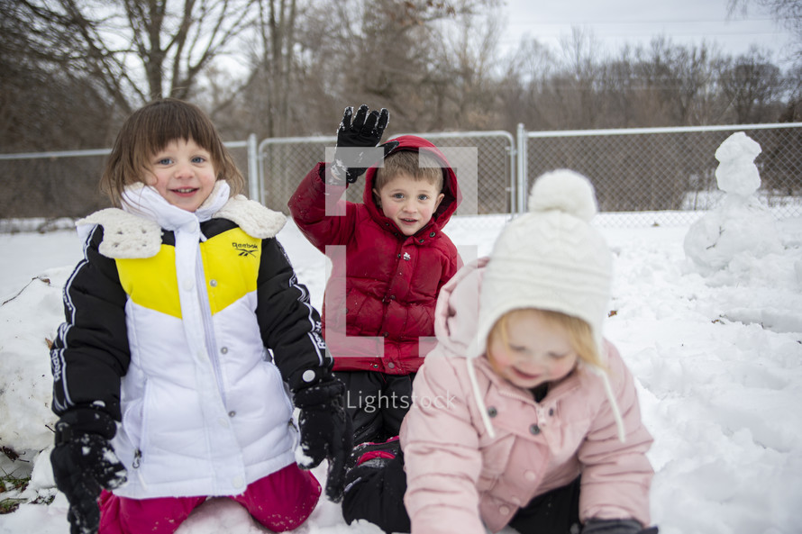 kids playing in snow outdoors 
