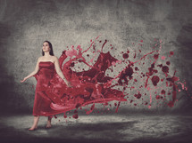 woman in a red dress of splashing paint