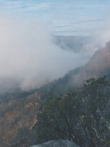 fog rising out of a valley