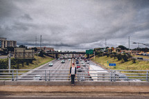 woman standing on an overpass