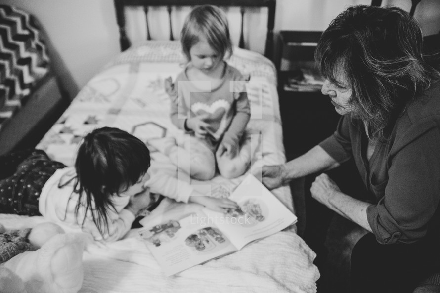 a grandmother reading to her grandchildren 
