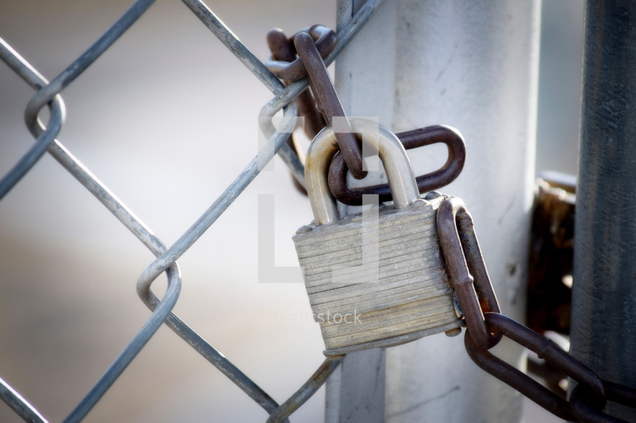 padlock on a chain link fence 