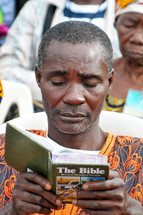African man reading Bible