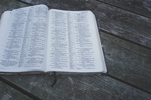 an open Bible on a deck 
