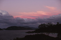 pink sky at sunset over islands 