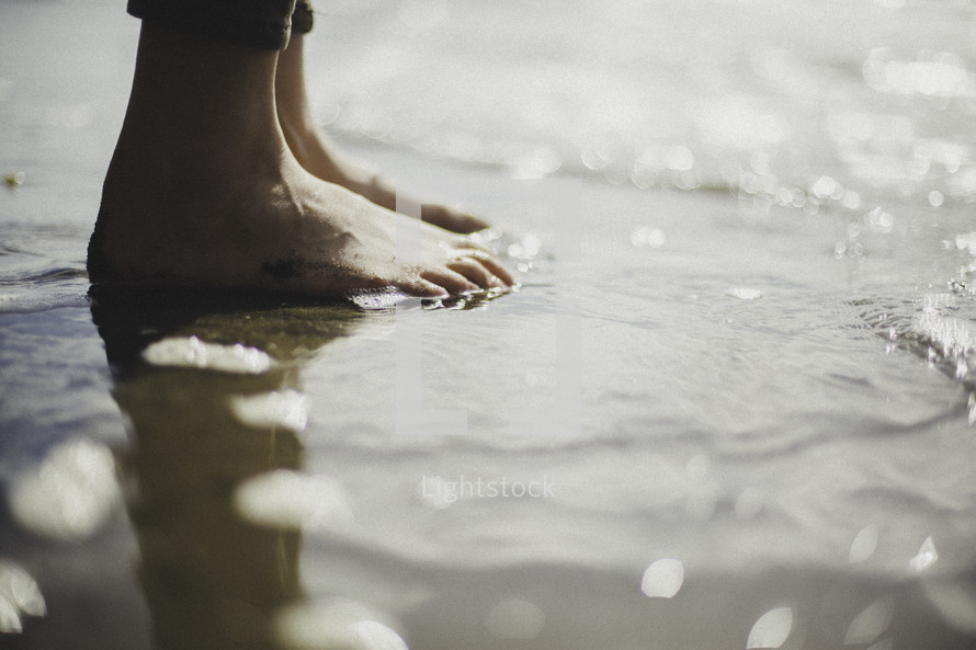bare feet in wet sand 