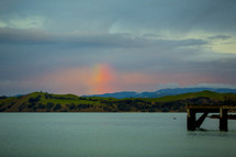 rainbow in the sky over a lake 