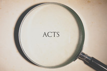 magnifying glass over Acts 