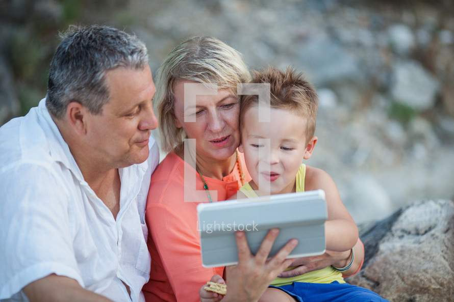 Grandparents and grandson with tablet PC