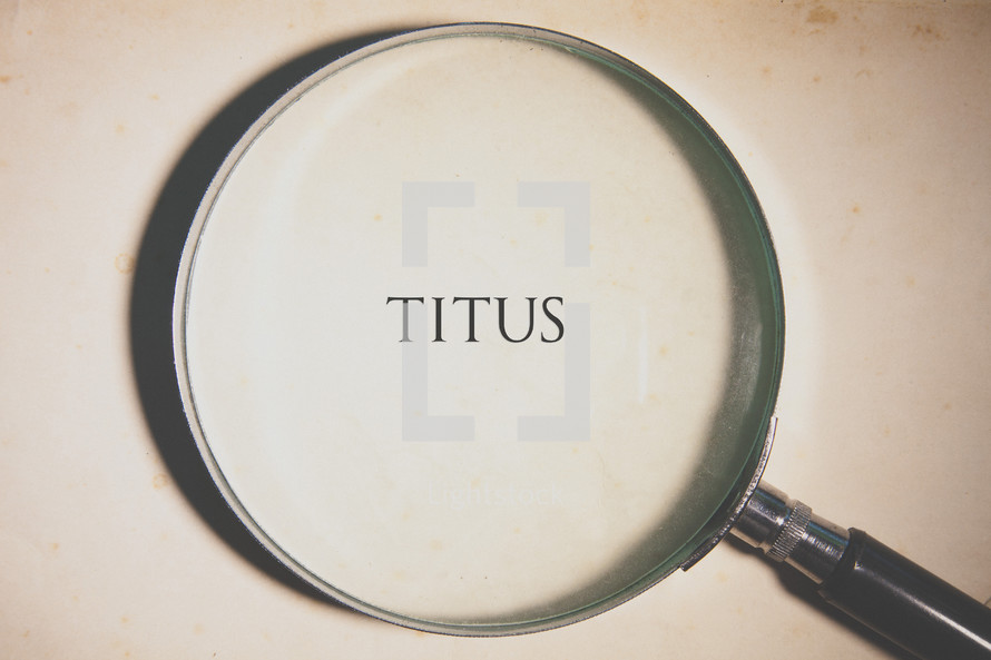 magnifying glass over Titus