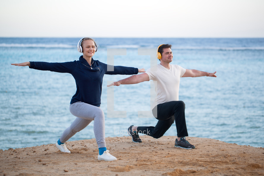 Young couple working out outdoor with music