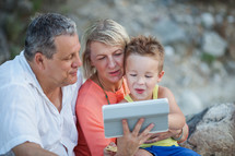 Grandparents and grandson with tablet PC