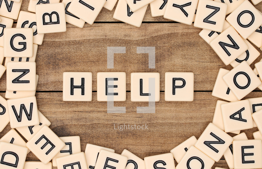 scrabble pieces and the word help