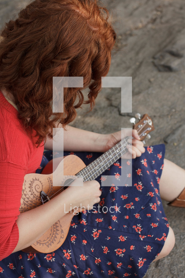 woman playing a ukulele 