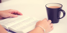 woman reading a Bible with coffee 