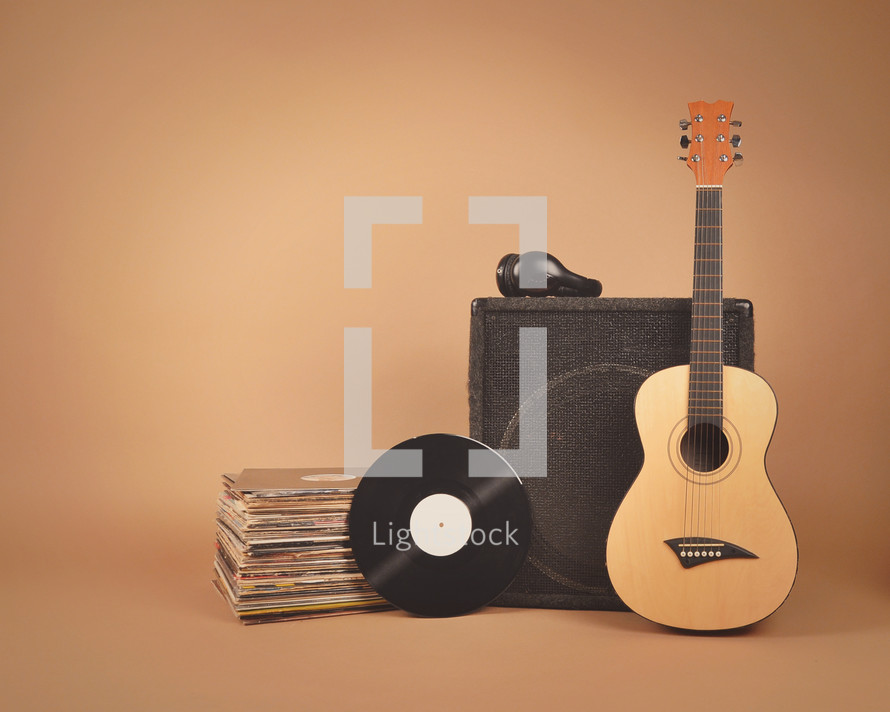 speaker, acoustic guitar, records, and headphones 