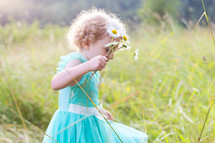 a little girl picking flowers 