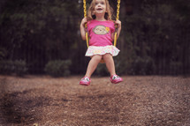 a girl child on a swing 