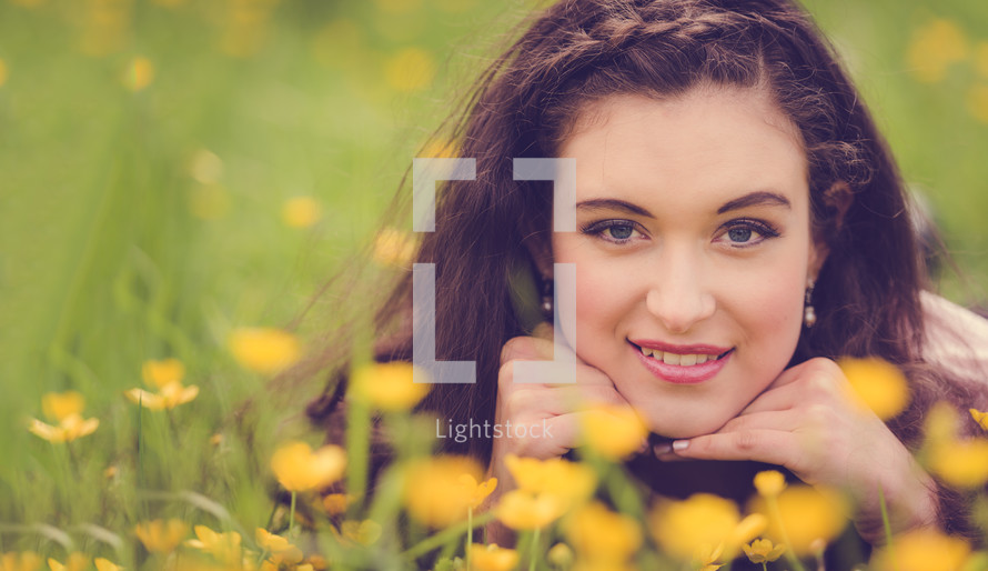 a portrait of a teen girl in a field of yellow wildflowers 
