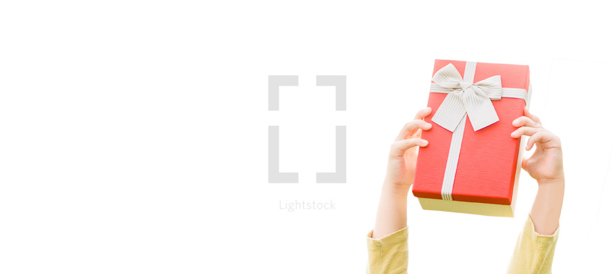 arms holding up a red Christmas gift against a white background 