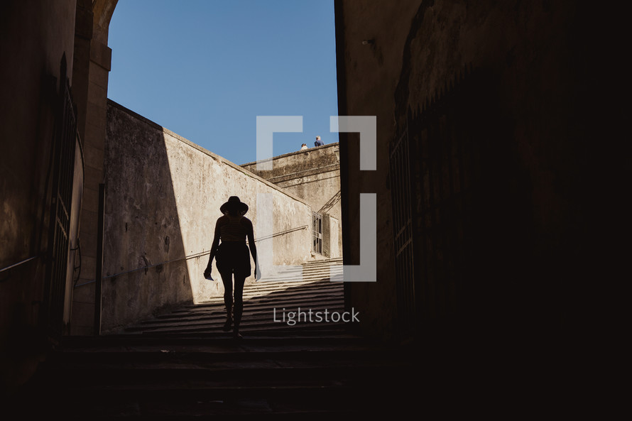 silhouette of a woman walking up stairs in Italy 