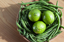 limes and green beans in a bowl 