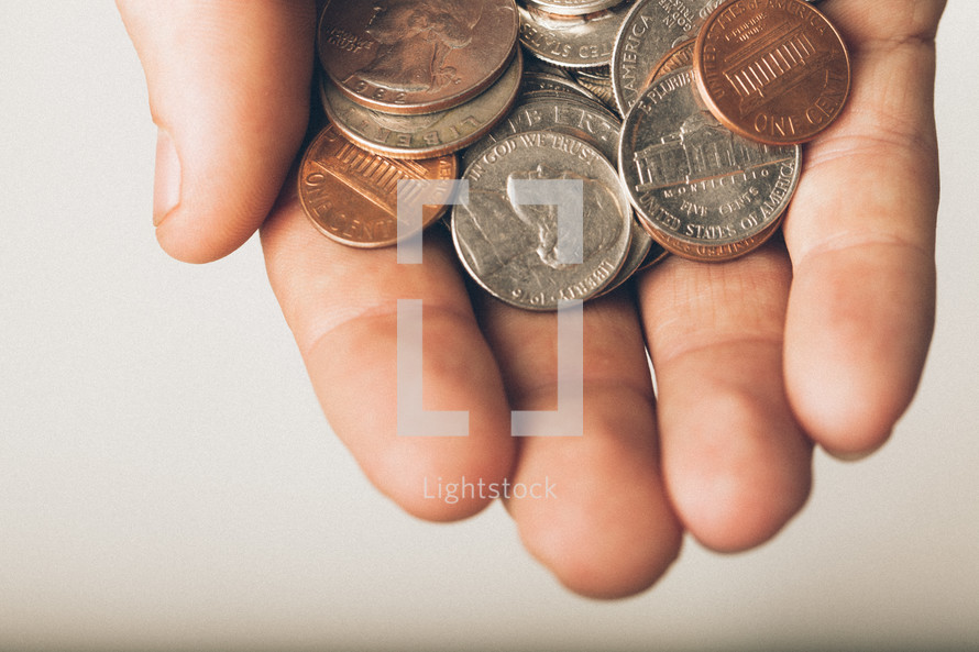 Hand holding coins.