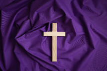 Cross on purple cloth background