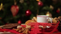 steaming mug in front of a Christmas tree 
