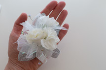 hand holding a corsage 