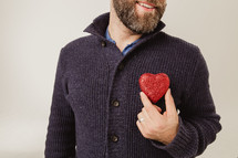 man holding a heart over his heart 