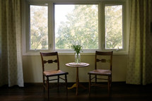 table and chair dinette set in a window 