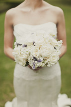 A bride holds her bouquet of flowers