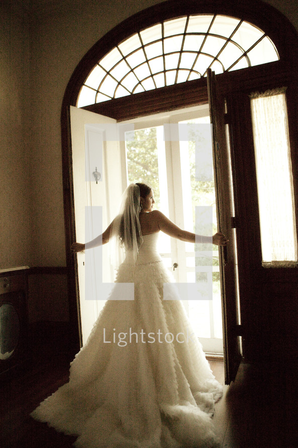 A bride opening the doors to walk outside