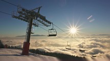 Beautiful sunny morning in winter season, mountains ski resort with empty chairlift 
