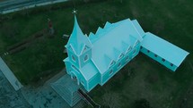 aerial view over a mint green church 