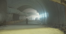 Workers inside a large tunnel construction project