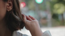 Close-up shot of a woman playing with her hair on a bus