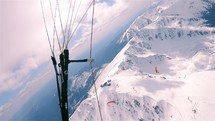 Paragliding over winter mountains.
