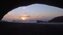 Beautiful sunset in Legzira Beach over huge rock arch in evening in Morocco Travel Background
