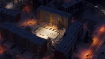 Kids playing ice hockey during winter at night