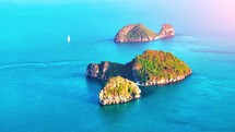 Aerial view of a small secluded tropical island in Thailand. Flight over small islands.	