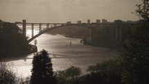 The view of Jardins do Palácio de Cristal at sunset, with the Douro River and Ponte da Arrábida Bridge in Porto in the background.