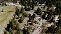 Aerial View Panning Up from Cabins to the Big Bear Forest