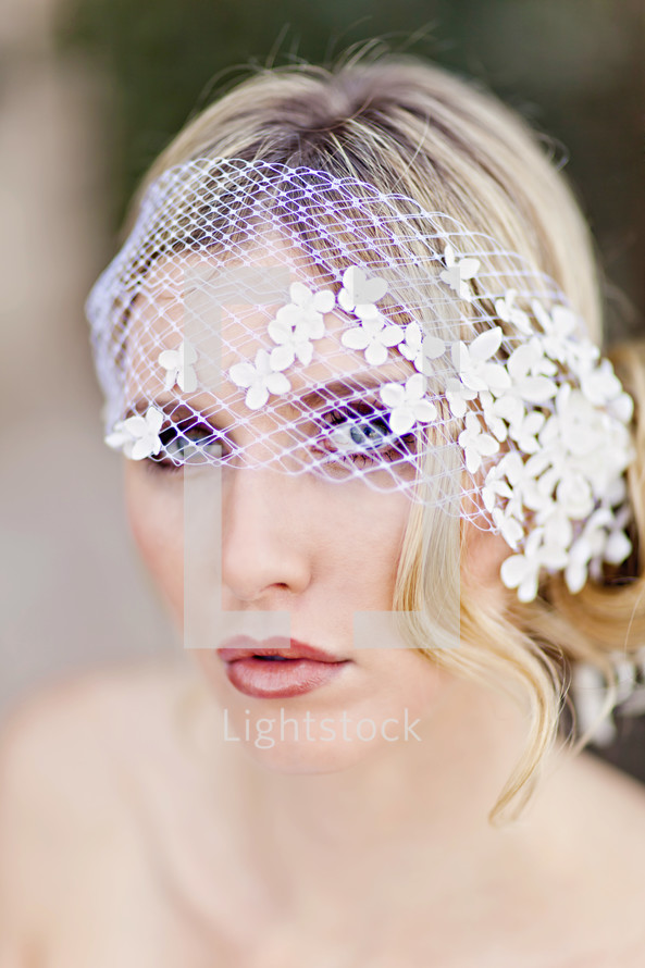 white lace over the eyes of a woman bride, bridal veil 