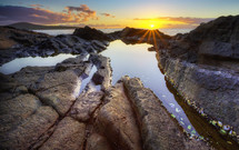 A sunset over a tide pool. 