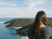 a woman standing at the top of a cliff overlooking Nelson Bay 