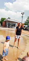 mother and kids at a splash park 