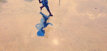 boy running at a splash pad 