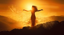 Young woman in long dress with arms outstretched looking at the sunset